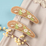 Load image into Gallery viewer, Radhu & Kabby Floral Embroidered Hair Clips | Beige Fabric with Cream Thread Roses & Beaded Edges
